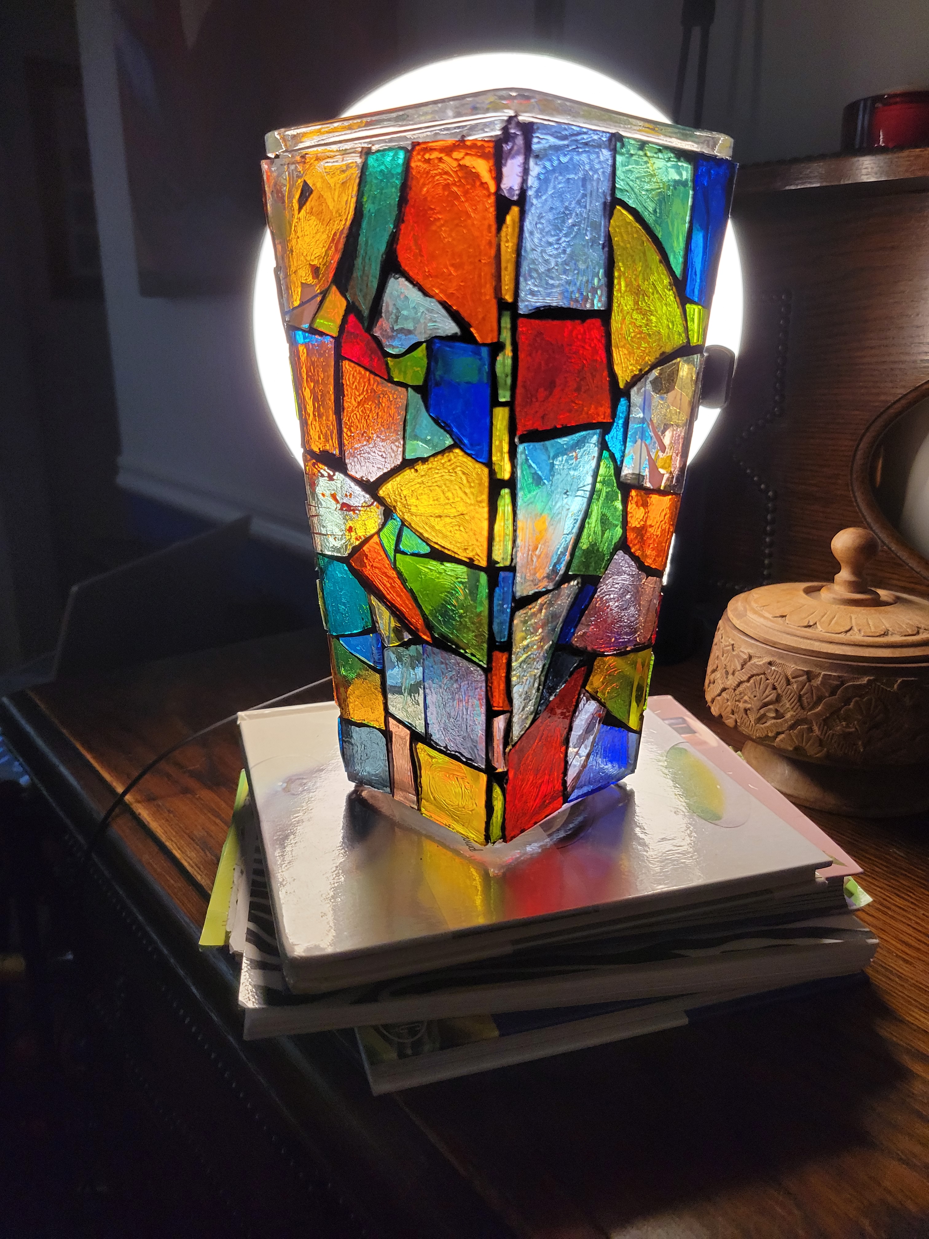 A mosaic vase made to look like stained glass 