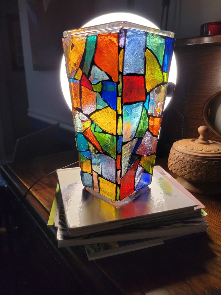 A mosaic vase made to look like stained glass