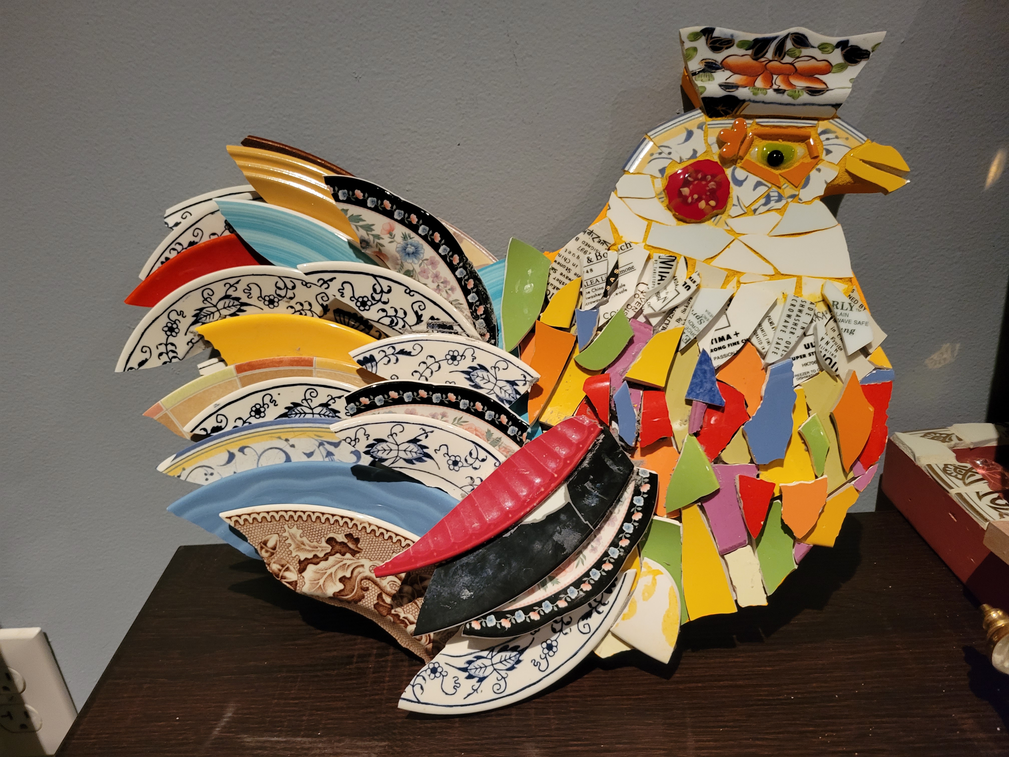 Either a chicken or a rooster, but a very colorful and happy fowl