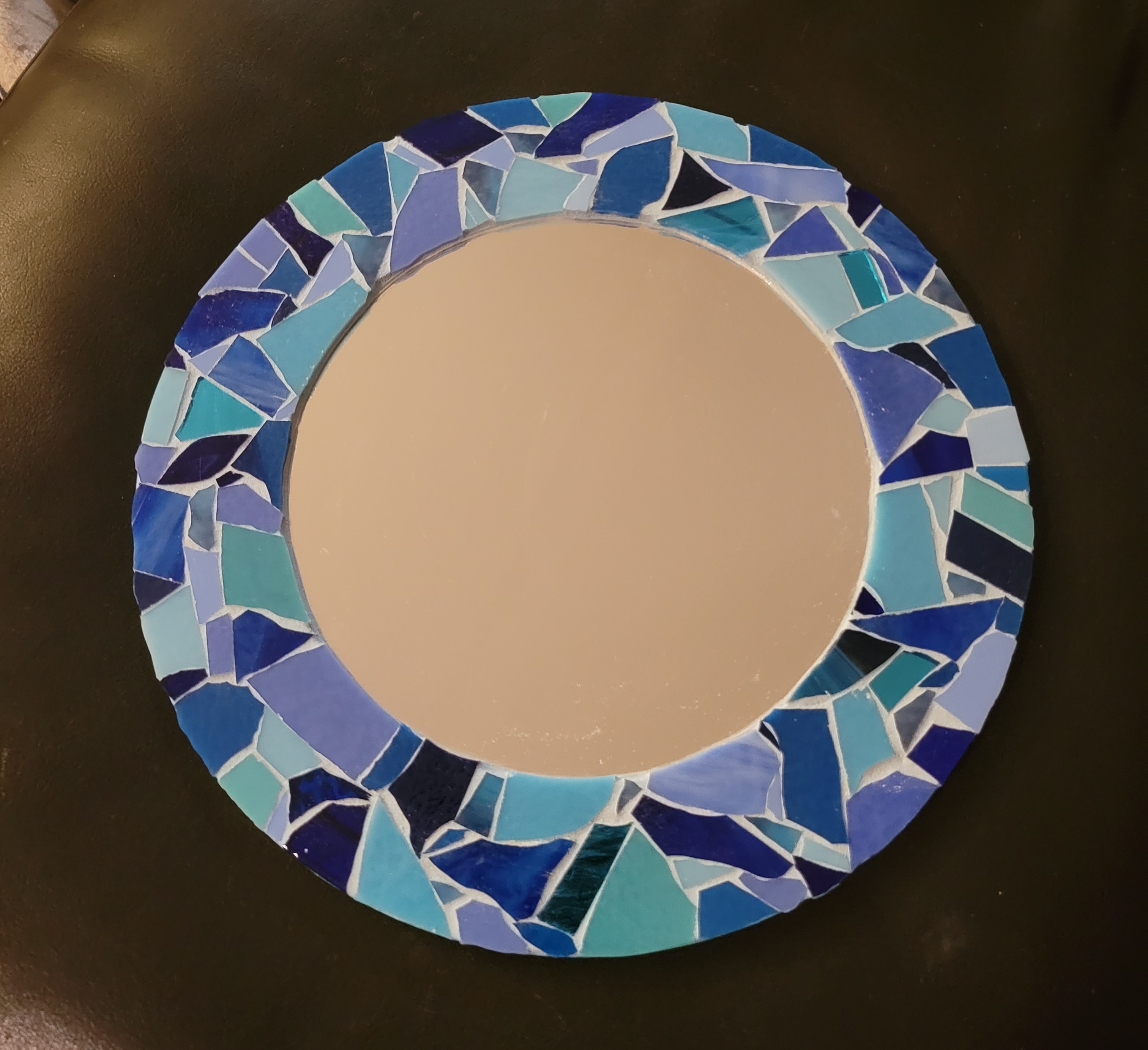 A mirror in various shades of blue